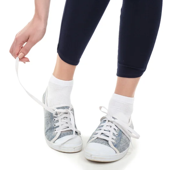 Young woman tying shoelace — Stock Photo, Image