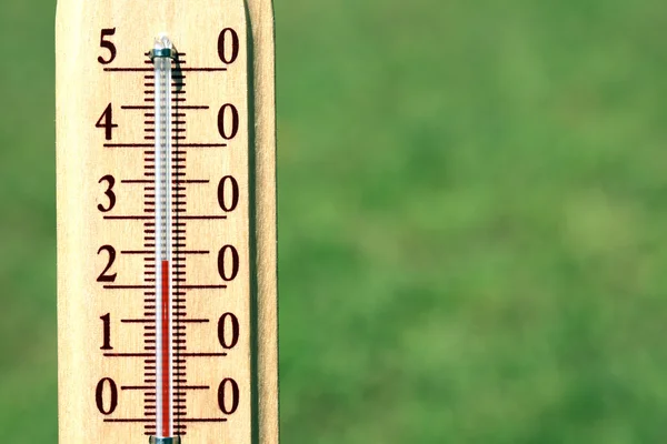 Thermometer on natural background — Stock Photo, Image