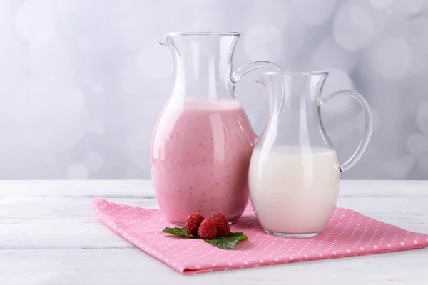 Glass jug of milk cocktail with raspberry taste — Stock Photo, Image