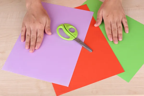 Woman hands and color paper for origami — Stock Photo, Image