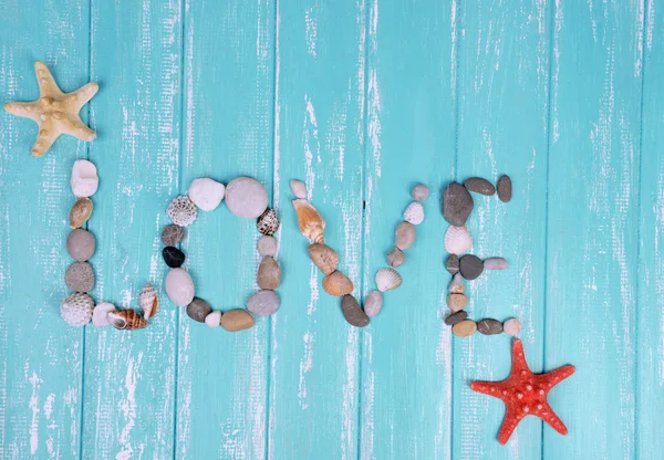 Word love made from sea shells and stones — Stock Photo, Image