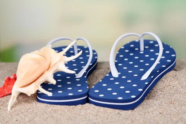 Color flip-flops on sand — Stock Photo, Image