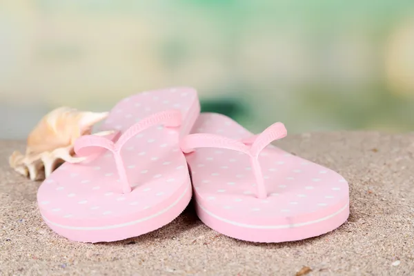 Color flip-flops on sand — Stock Photo, Image