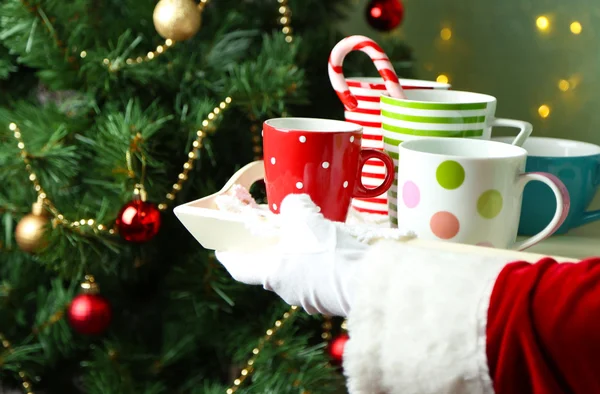 Santa holding  tray with mugs — Stock Photo, Image