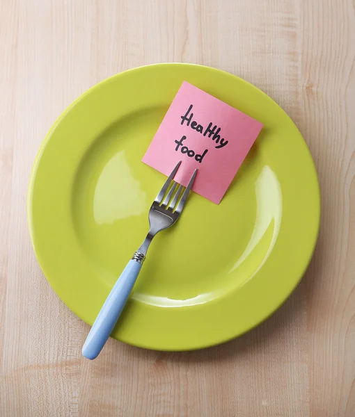 Paper with message attached to fork, on plate — Stock Photo, Image
