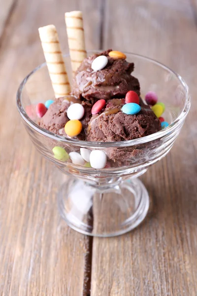 Chocolate ice cream with candies and wafer rolls — Stock Photo, Image