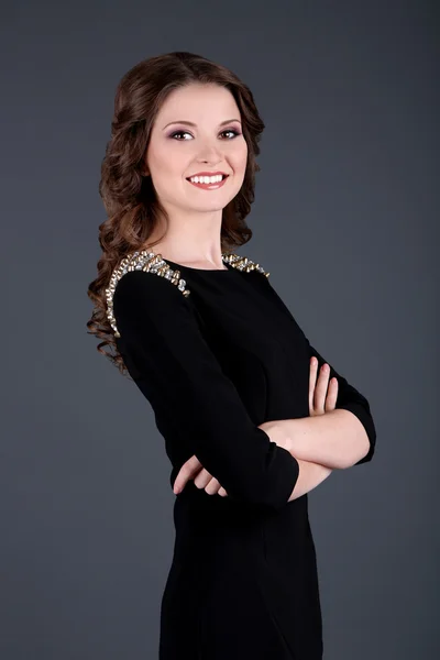 Beautiful young girl in dress on grey background — Stock Photo, Image