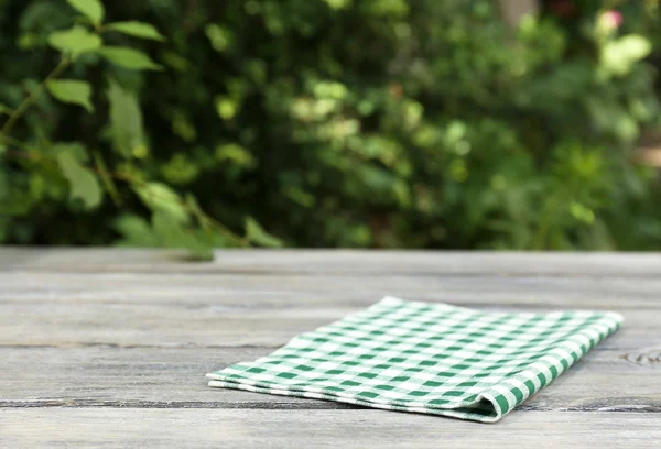 Wooden table with tablecloth — Stock Photo, Image