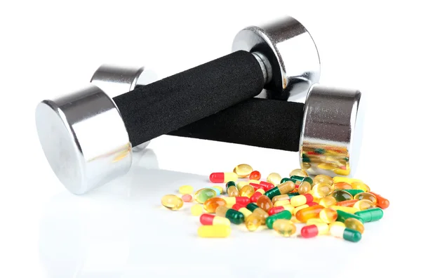 Dumbbells and colorful pills — Stock Photo, Image