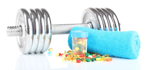 Dumbbell and colorful pills — Stock Photo, Image