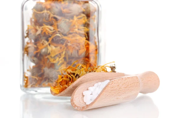 Tablets and bottle with herbs Stock Photo