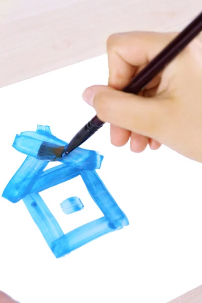 Child draws house with watercolors — Stock Photo, Image