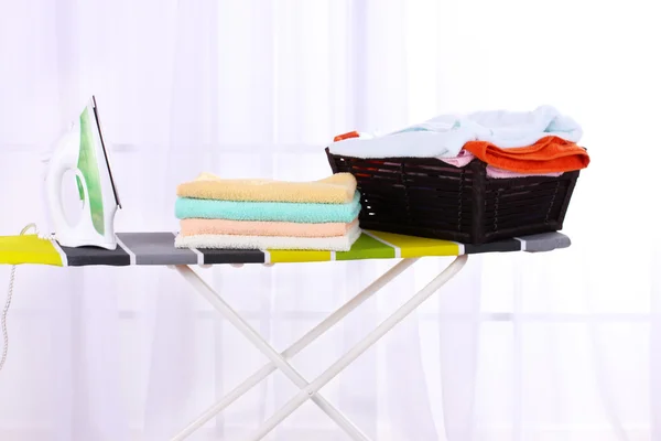 Basket with laundry and ironing board — Stock Photo, Image