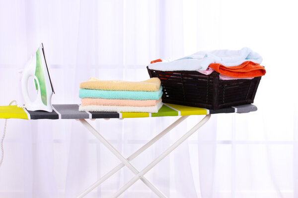 Basket with laundry and ironing board