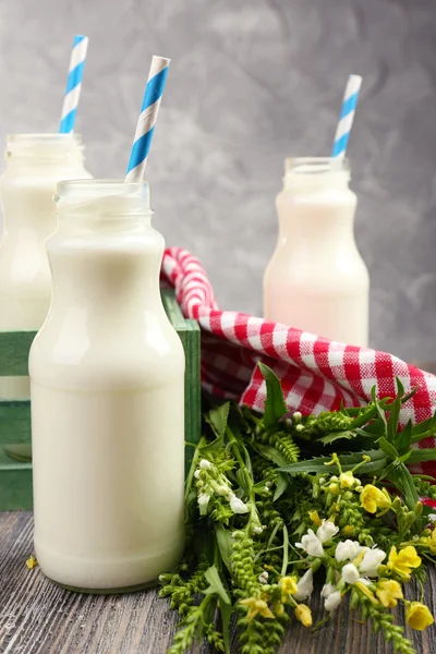 Молоко в бутылках с бумажными соломинками — стоковое фото