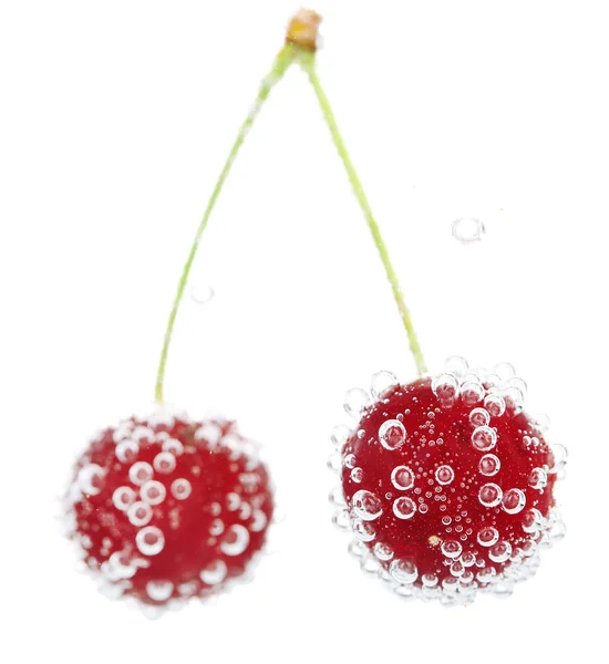 Cherry in water with bubbles — Stock Photo, Image