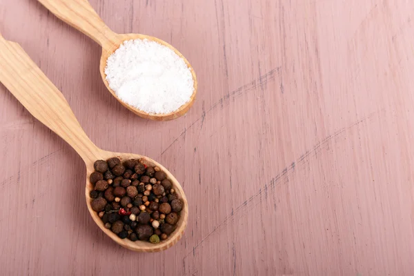 Salt and pepper in spoon — Stock Photo, Image