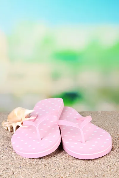 Pink flip-flops on sand — Stock Photo, Image