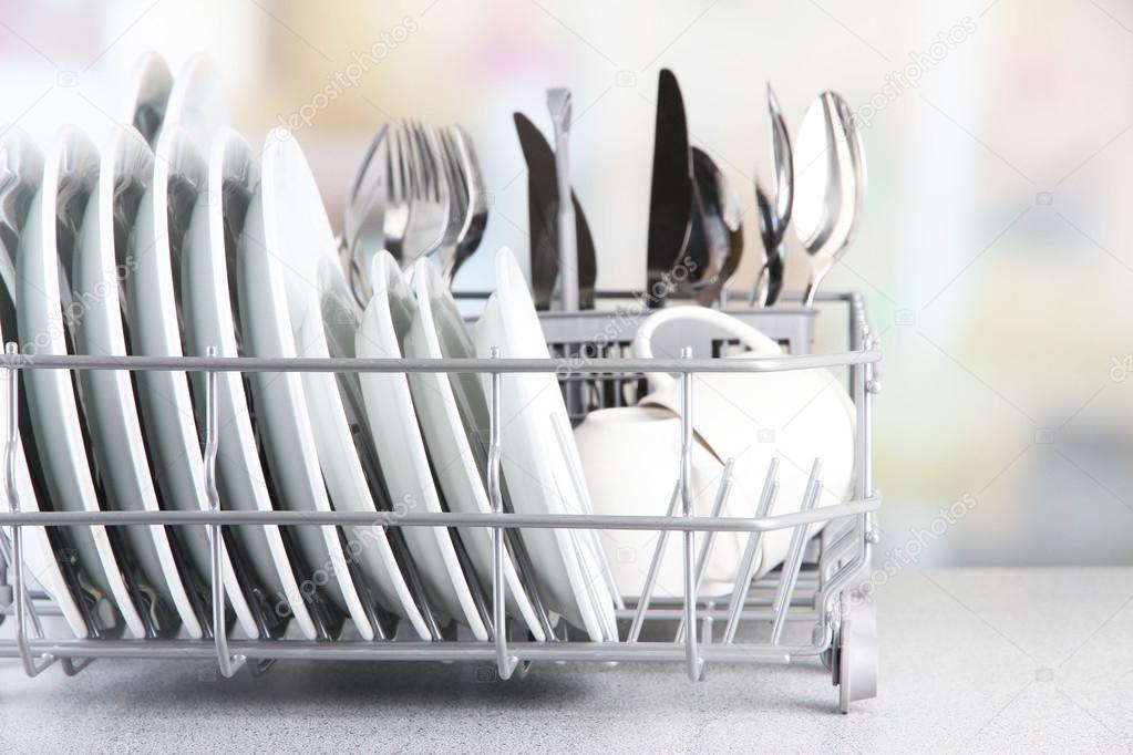 Clean dishes drying on metal dish rack