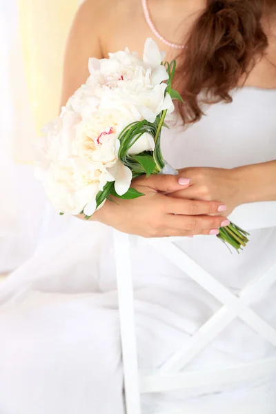 Mariée tenant un bouquet de pivoines blanches, gros plan, sur fond clair — Photo