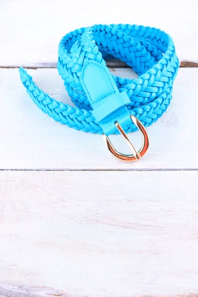 Blue leather belt on wooden background — Stock Photo, Image