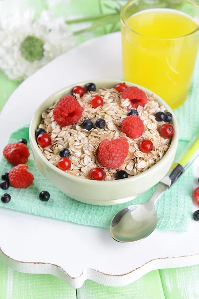 Tasty oatmeal with berries on table close-up — Stock Photo, Image