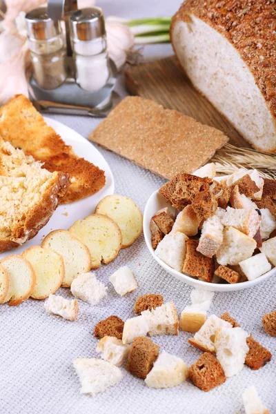 Homemade croutons on table in kitchen, close up — Stock Photo, Image