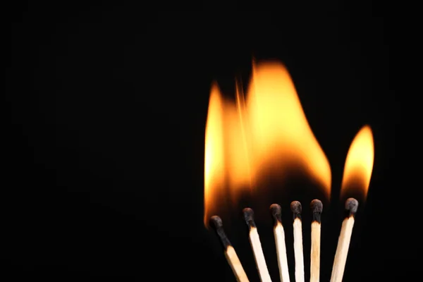 Burning matches isolated on black — Stock Photo, Image