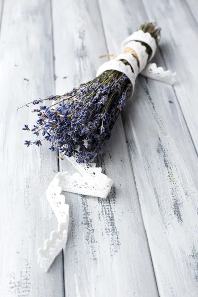 Lavender flowers on color wooden background — Stock Photo, Image
