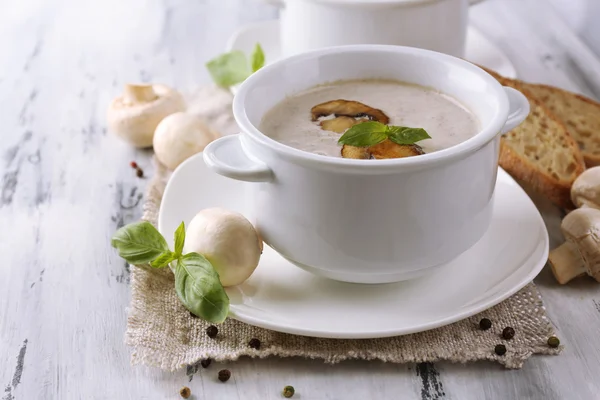 Mushroom soup in white pots, on napkin, on wooden background — Stock Photo, Image