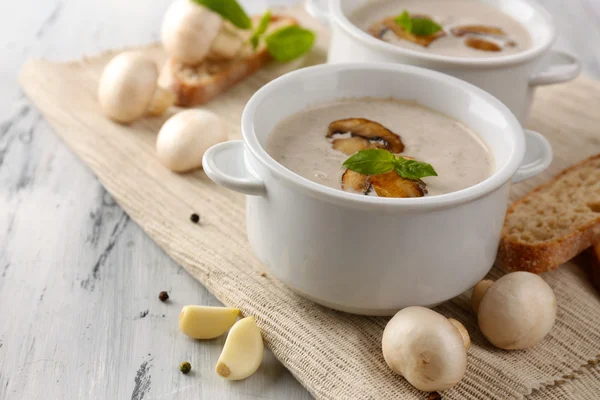 Mushroom soup in white pots, on napkin,  on wooden background — Stock Photo, Image