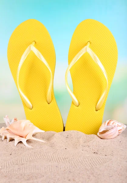 Bright flip-flops on sand, on nature background — Stock Photo, Image