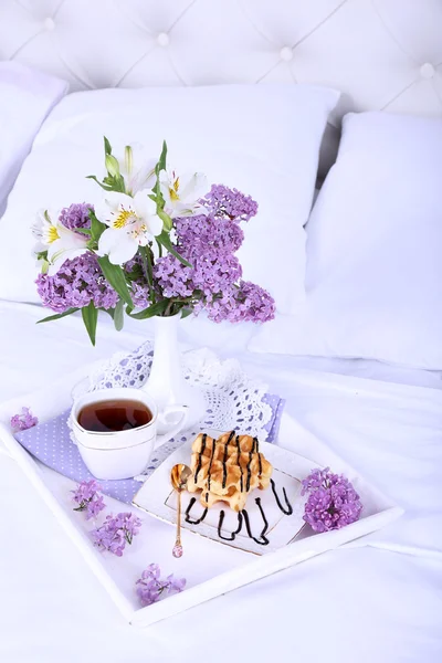 Wooden tray with light breakfast on bed — Stock Photo, Image