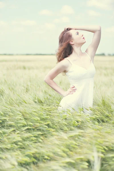 Mooie jonge vrouw in het veld — Stockfoto