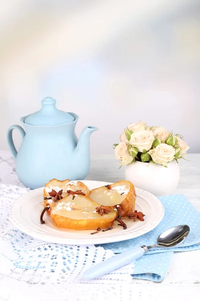 Baked pears with syrup on plate, on bright background — Stock Photo, Image