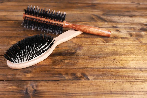 Wooden hairbrushes on wooden background — Stock Photo, Image