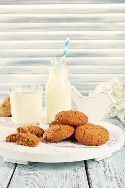Milk and cookies on tray on table — Stock Photo, Image