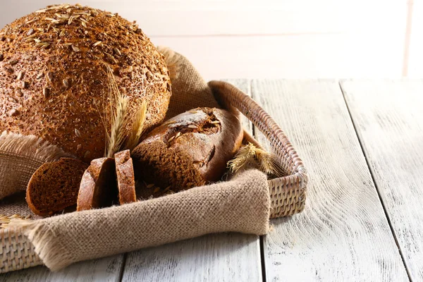 Fresh bread on wooden table — Stock Photo, Image