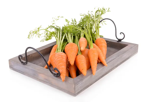 Fresh carrot with leaves on wooden tray isolated on white — Stock Photo, Image