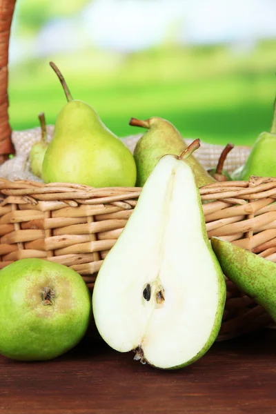 Pears in  wicker basket, on bright background — Stock Photo, Image