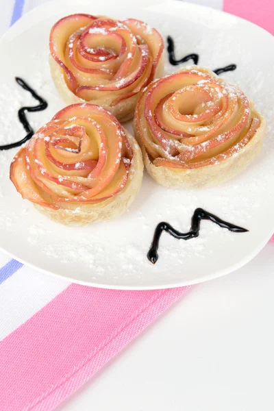 Tasty puff pastry with apple shaped roses on plate close-up — Stock Photo, Image