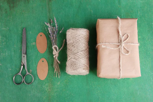 Natural style handcrafted gift box on color wooden background. Concept of natural style design — Stock Photo, Image