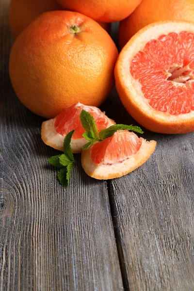 Спелые грейпфруты на деревянном фоне — стоковое фото