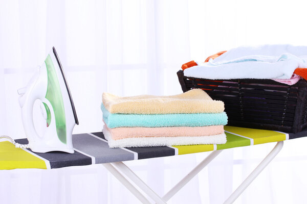 Basket with laundry and ironing board