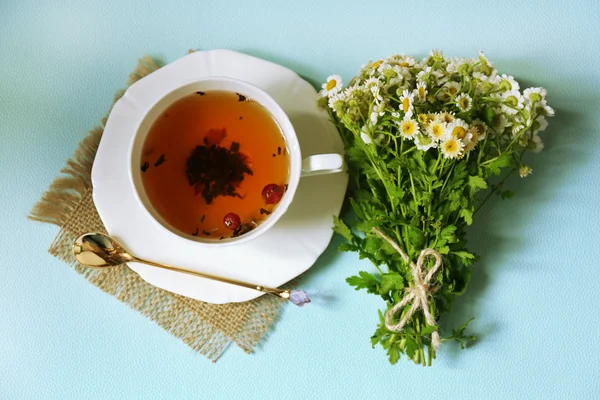 Xícara de chá de ervas frescas na mesa — Fotografia de Stock