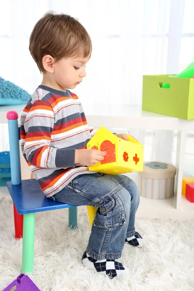 Cute little boy playing in room — Stock Photo, Image