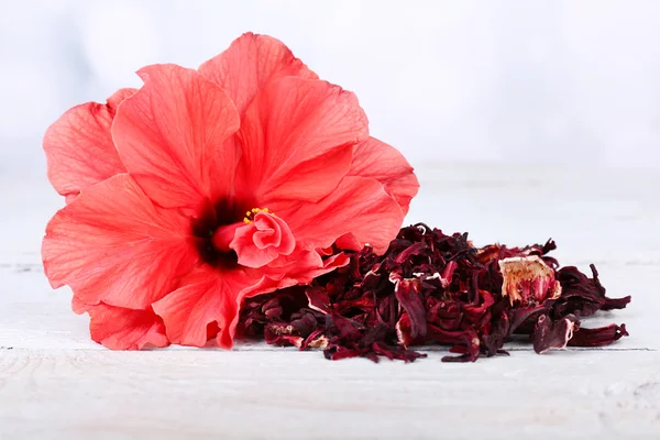Hibiscus tea and flower on wooden table, on light background — Stock Photo, Image