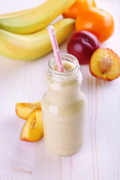 Bottle of delicious smoothie on table, close-up — Stock Photo, Image