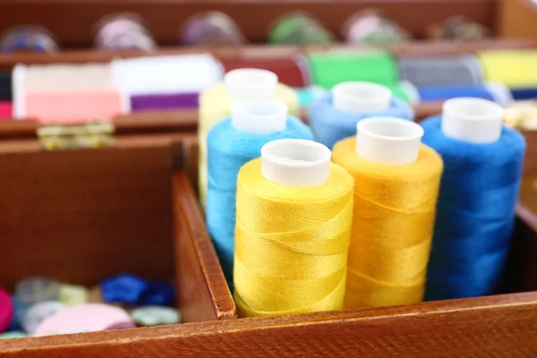 Colorful threads for needlework in wooden box close up — Stock Photo, Image