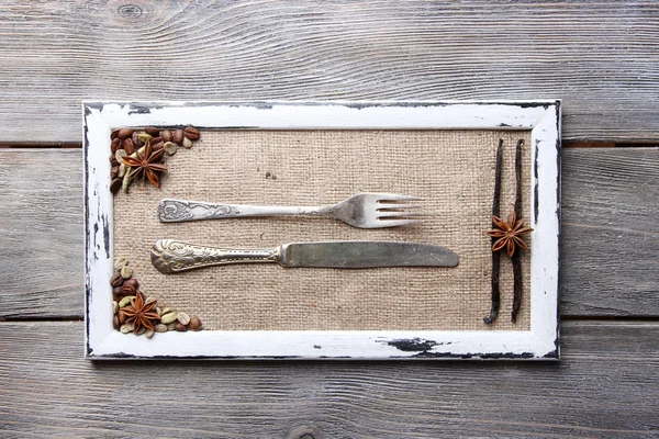 Wooden frame, spices and vintage cutlery — Stock Photo, Image